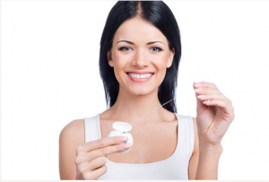 Woman pulling floss out of container 49441 Dentist