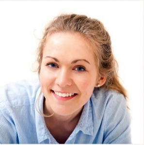 Blonde woman smiling and posing Dentist in Muskegon